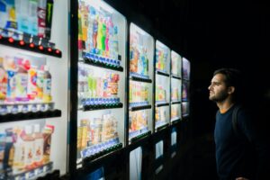 Man looking at vending machine with many choices